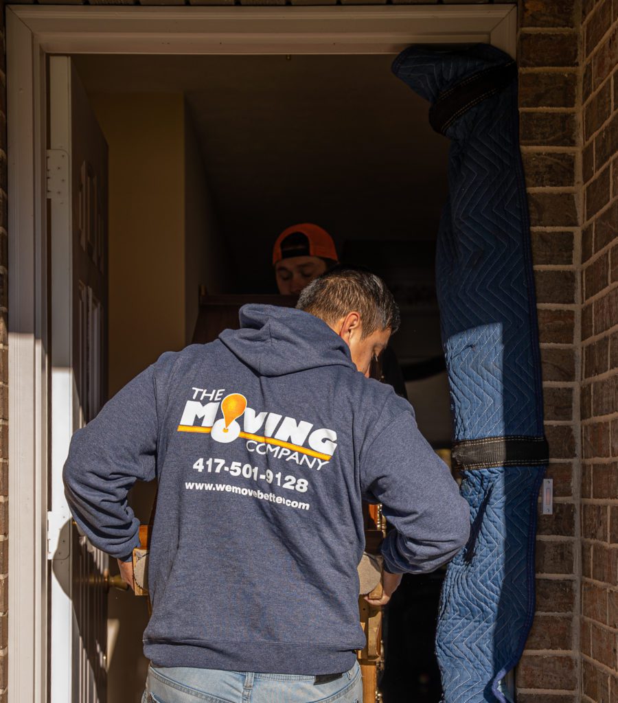 rear view of the moving company team member in branded hoodie
