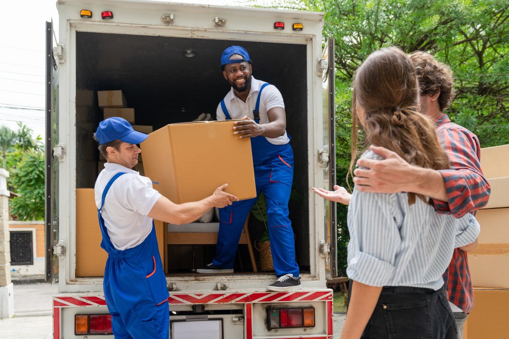 Professional movers unloading moving truck